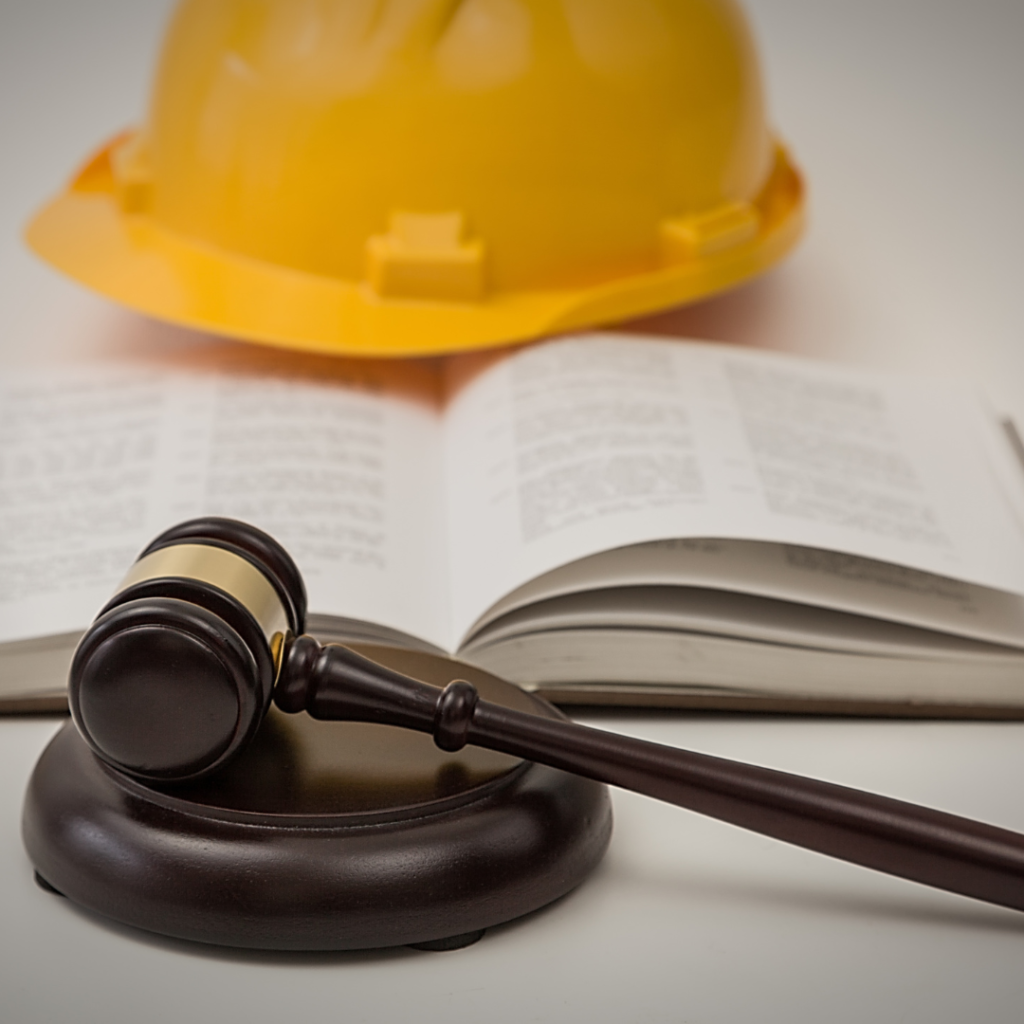 a hard hat, gavel and a book 